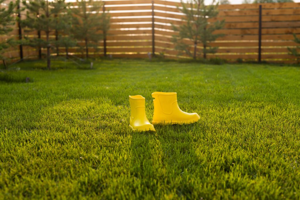 Yellow boots on a lush green lawn